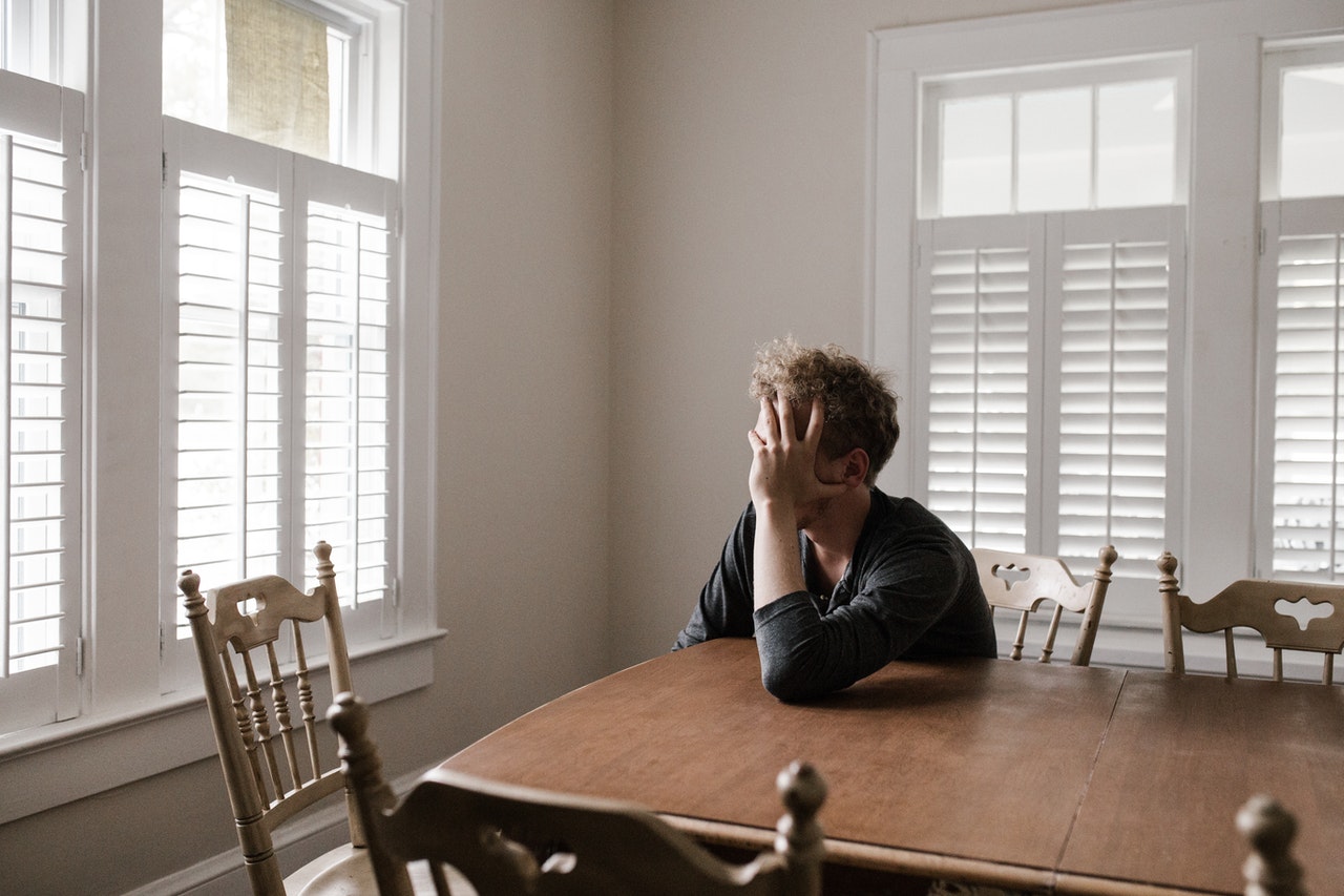 photo-of-man-leaning-on-wooden-table-3132388.jpg